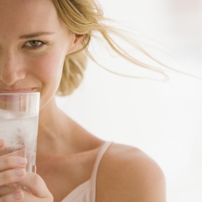 Woman holding glass of water