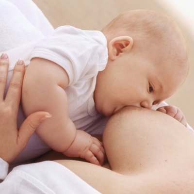 Close-up of mother breastfeeding baby girl (6-12 months)