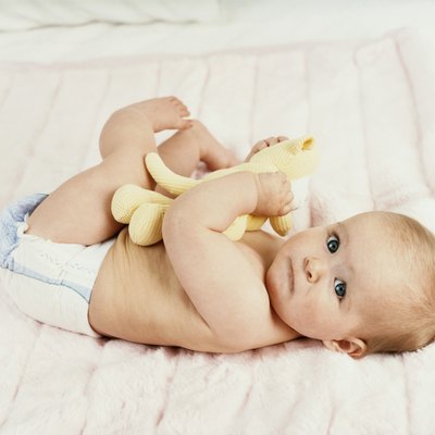 Portrait of a Baby Lying on a Bed