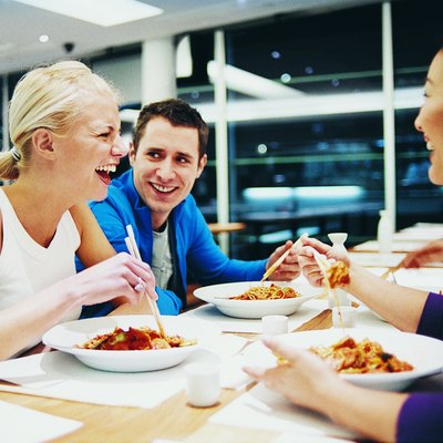 Three People Enjoying a Meal in a Chinese Restaurant