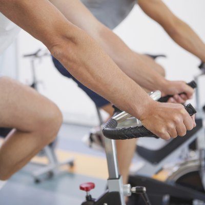 Fit people working out on the exercise bikes