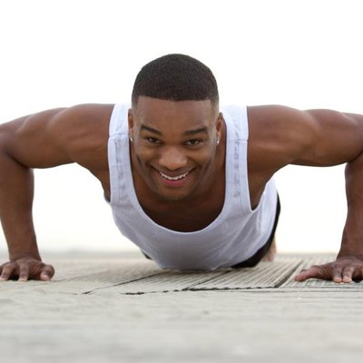 Close up portrait of a smiling man doing push ups