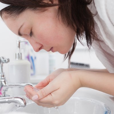 Young woman washing face
