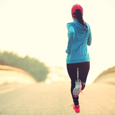 young fitness woman runner running on road