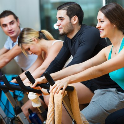 Adults riding stationary bicycles