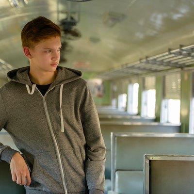 Teenager boy traveling with train