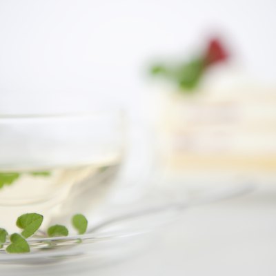 Herbal tea with cake in the background