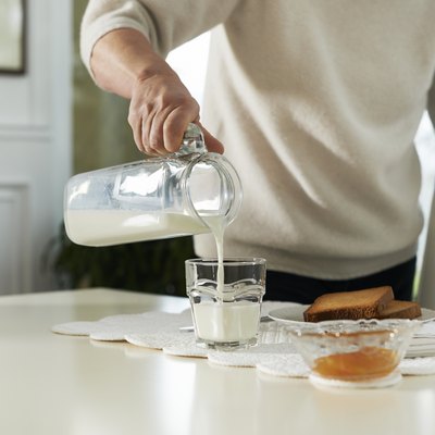 Portrait of senior woman having breakfast with milk