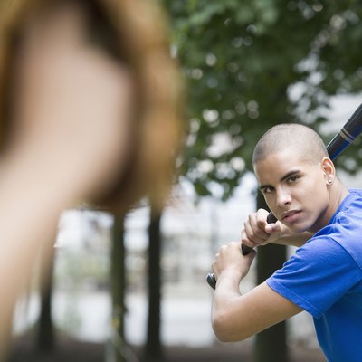 Teenage baseball batter facing pitcher.