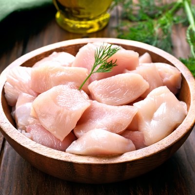 Chicken meat in wooden bowl