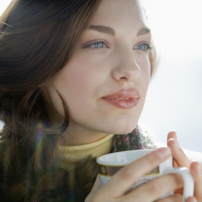 Portrait of young woman drinking coffee