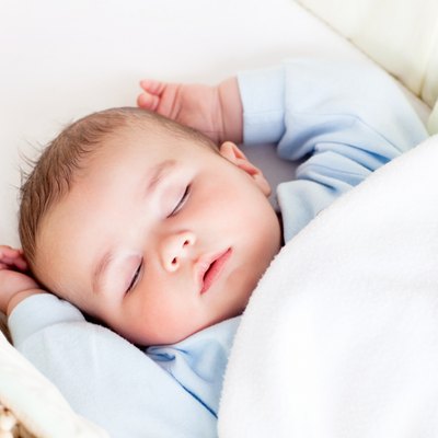 Portrait of a peaceful baby sleeping in his cradle at home