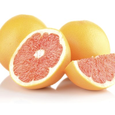 Studio shot sliced some grapefruits isolated white