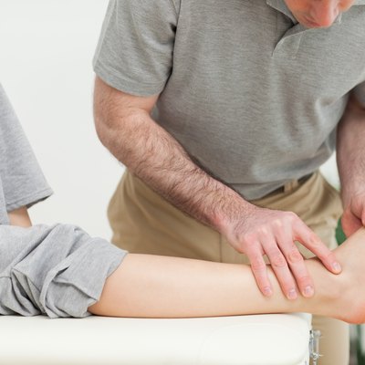 Doctor examining the foot of a woman