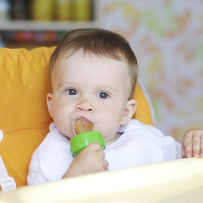 nice baby eats fruits by using nibbler