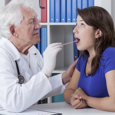 General practitioner examining throat