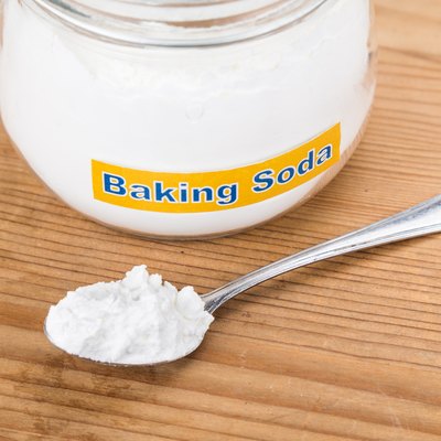 Jar and spoonful of baking soda for multiple holistic usages