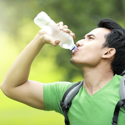 thirsty man drinking a bottle of water