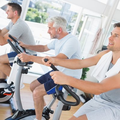 Men exercising on fitness bikes