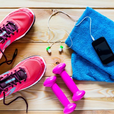 Women's running shoes and dumbbells for training