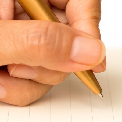 Women writing on paper with a pen on a white background.