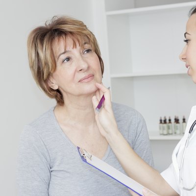 Young female doctor examining her patient