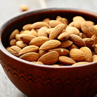 Almonds in ceramic bowl, raw food ingredients