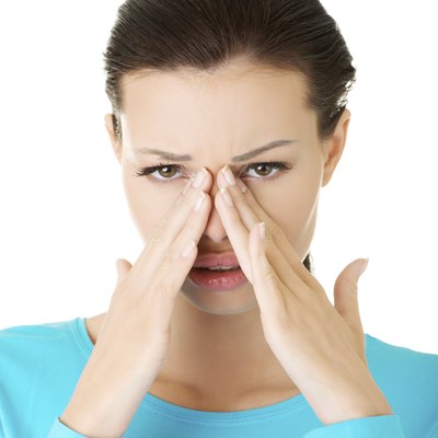 Attractive woman touching her nose.