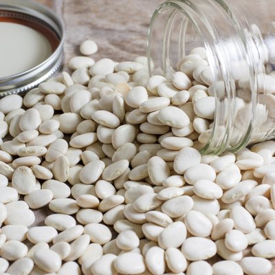 Dry Lima beans spilled on a countertop