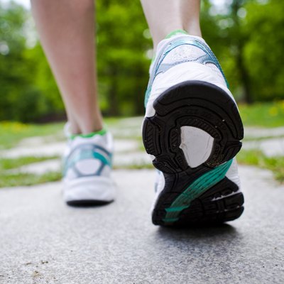 Woman walking cross country and trail in spring forest