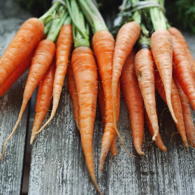 Fresh organic carrots on wooden background, selective focus