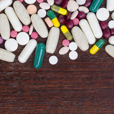 many colorful medicines on wood table
