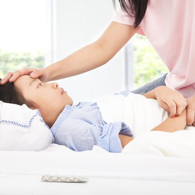Mother checking temperature of sick daughter by hand