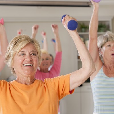 Seniors exercising with dumbbells in a health club