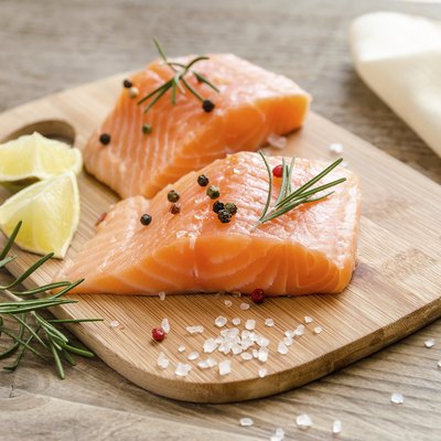 Raw salmon steaks on the wooden board