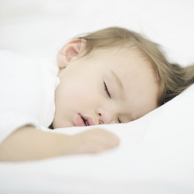 Baby sleeping on white bed