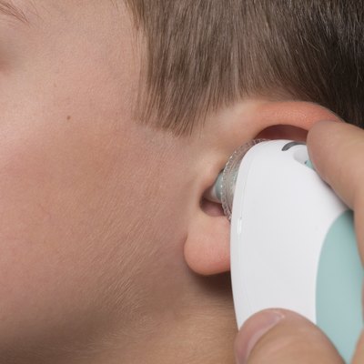 Young boy has his temperature taken
