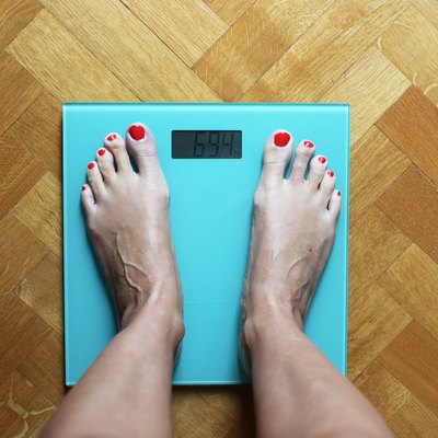 Woman standing on weighing scales
