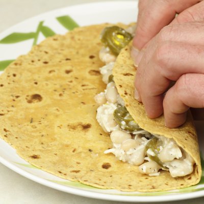 Hands Rolling a Vegetarian Wrap