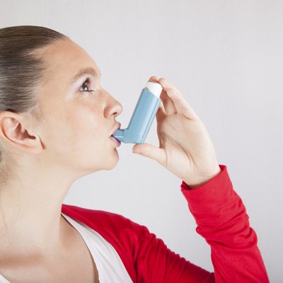 Cute girl with asthma inhaler