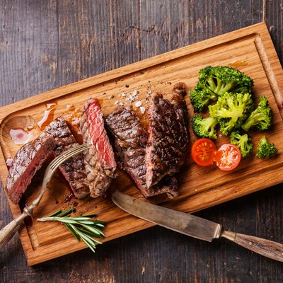 Sliced medium rare grilled steak Ribeye with broccoli