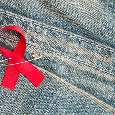 Aids awareness ribbon pinned on to jeans