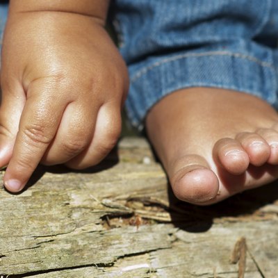 Child hand and foot outdoors