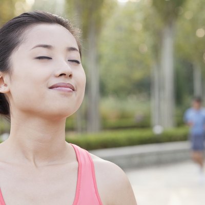 Young Woman With Eyes Closed in Park in Beijing
