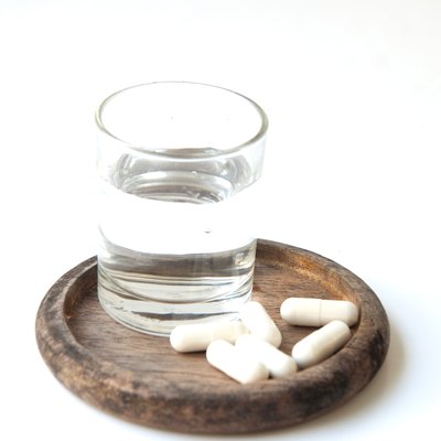 Many pills and glass water