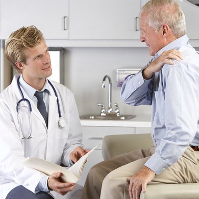 Doctor Examining Male Patient With Shoulder Pain