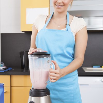 Woman Making Strawberry Milkshake
