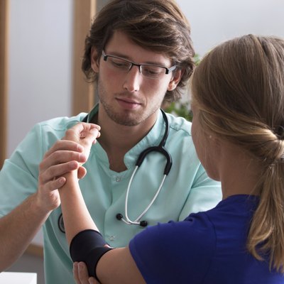Orthopedist examining elbow