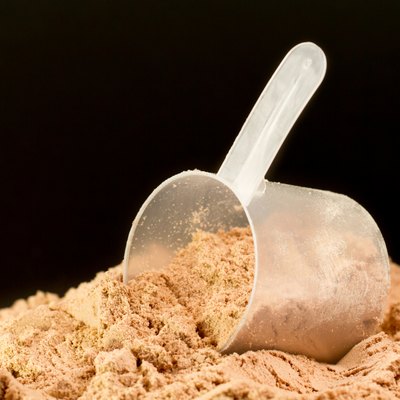 Whey protein drink powder on a black background