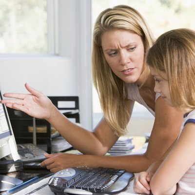 Woman and girl in home office with computer looking unhappy